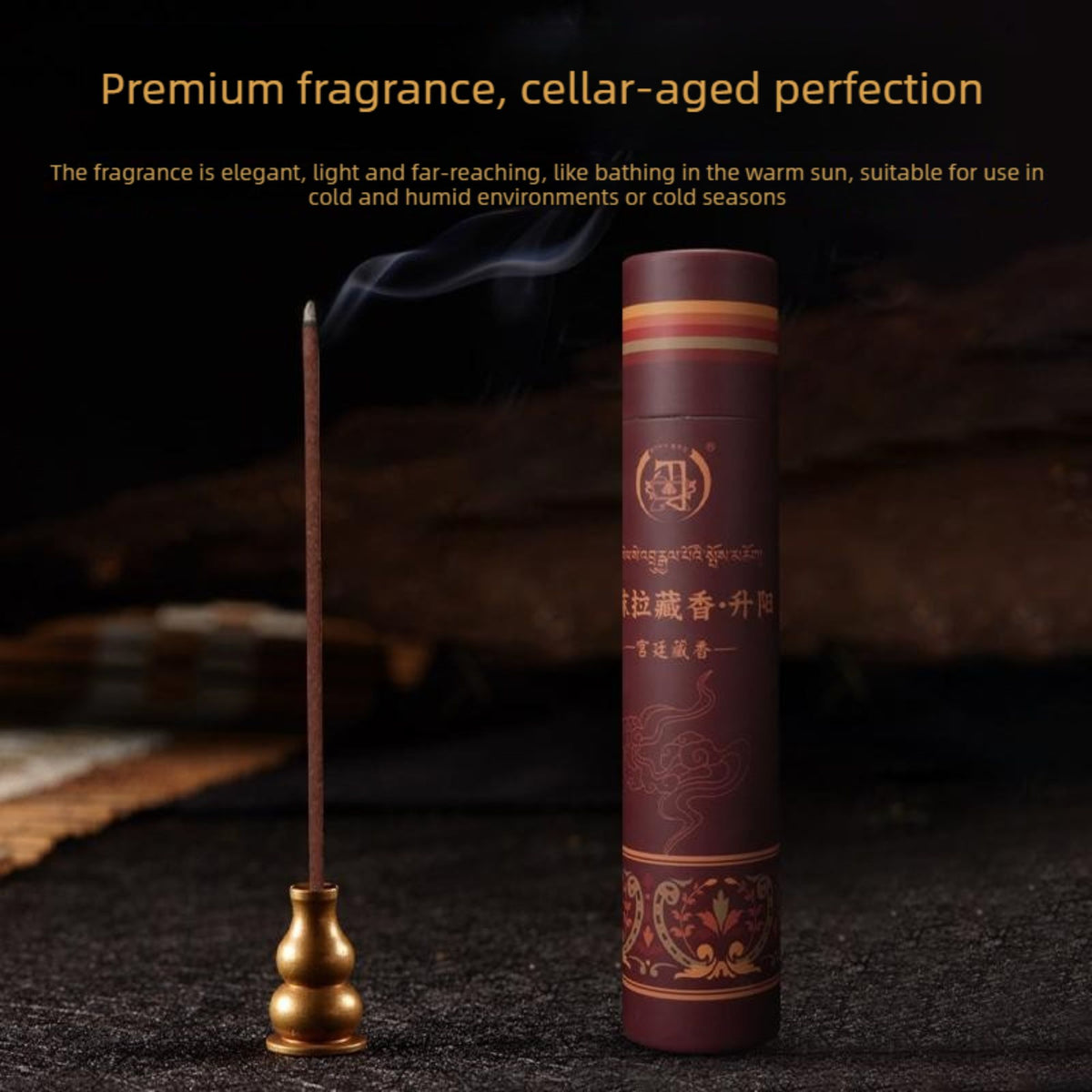A cylindrical dark brown incense stick holder with gold decorative patterns stands next to a single lit incense stick resting in a small gold holder. The scene is set on a dark textured surface with a blurred dark background, featuring promotional text at the top.